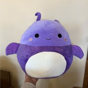 This is an Original Squishmallows Axel the Purple Beetle plush toy.